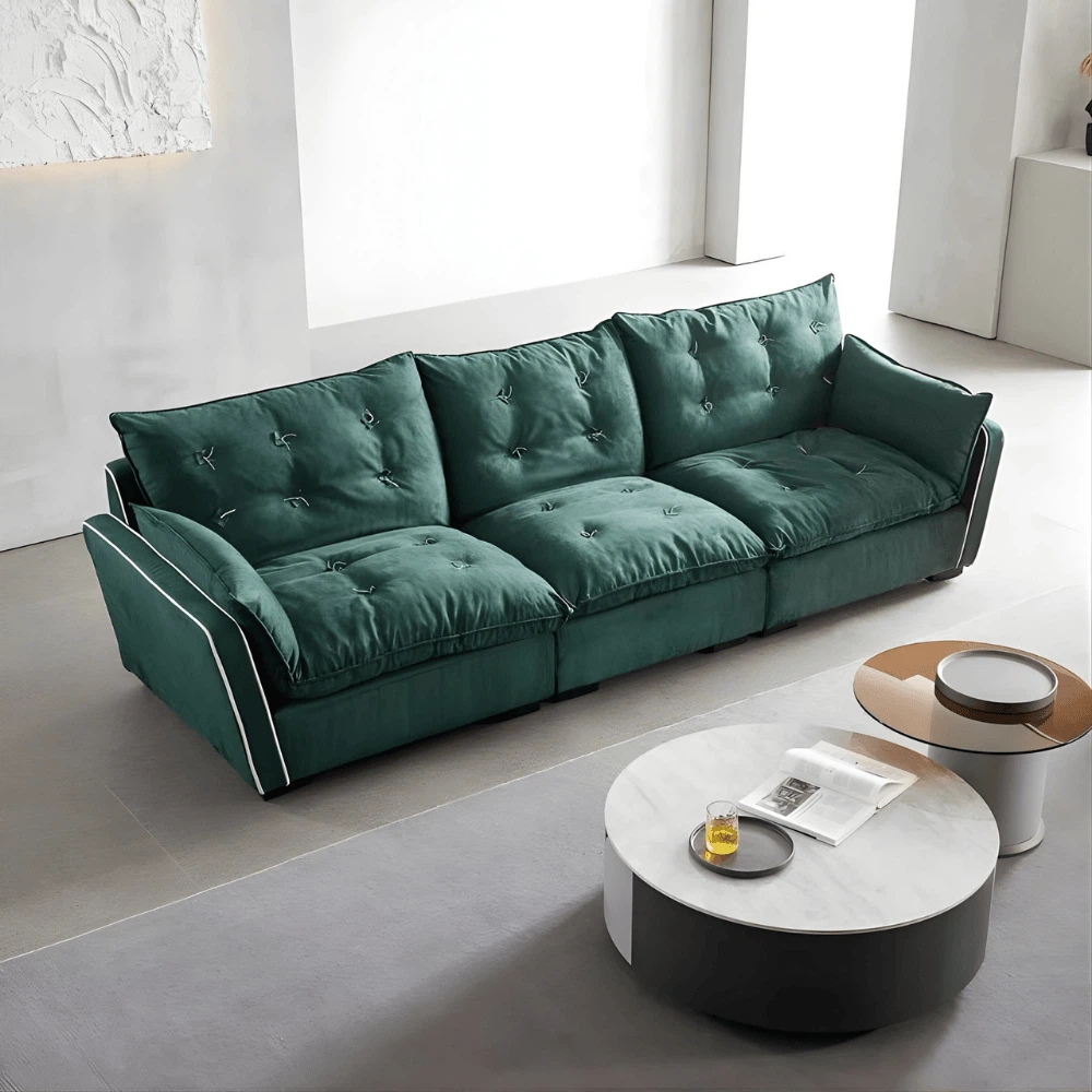 Living room setup featuring a green velvet sofa and a yellow lounge chair, paired with round marble coffee tables. Living room setup featuring a green velvet sofa and a yellow lounge chair, paired with round marble coffee tables.