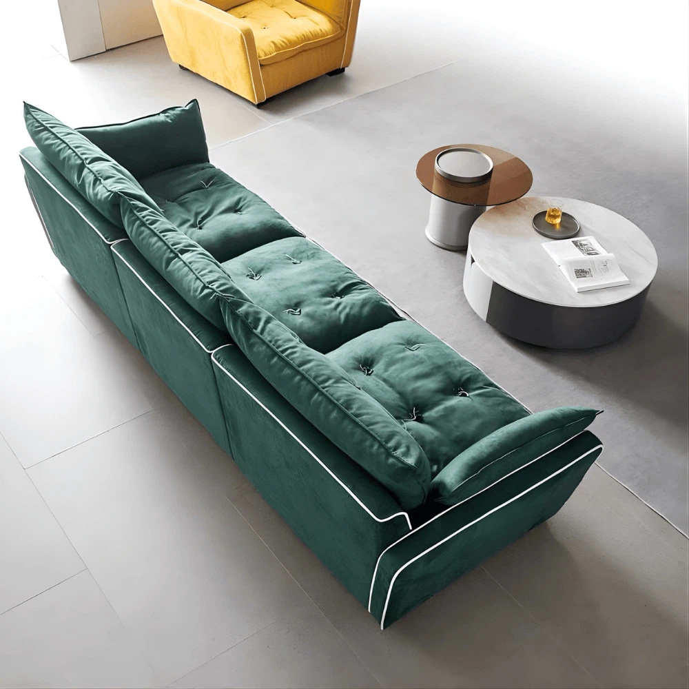 Overhead angle of the Modern Green Velvet Sofa in a bright modern living space with neutral flooring and minimalist decor. Overhead angle of the Modern Green Velvet Sofa in a bright modern living space with neutral flooring and minimalist decor.